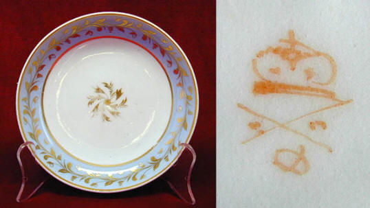 Fig. 4 A Derby saucer with a very faint mark in the Bute shape with pale blue border. The matching saucer, coffee can and tea cup all bear the same mark.