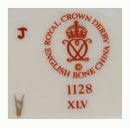 1976-modern times The crown and interlinked D's are now within a circle of ROYAL CROWN DERBY - ENGLISH BONE CHINA. The © copyright character below the Derby logo. This mark including popular Imari pattern number 1128 and with Roman Numeral year cypher for 1982. 