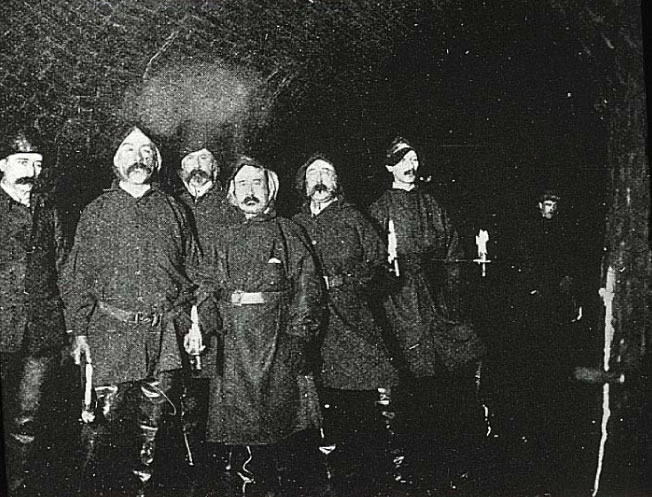 A gang of sewer-flushers–employed by the city, unlike the toshers–in a London sewer late in the 19th century.
